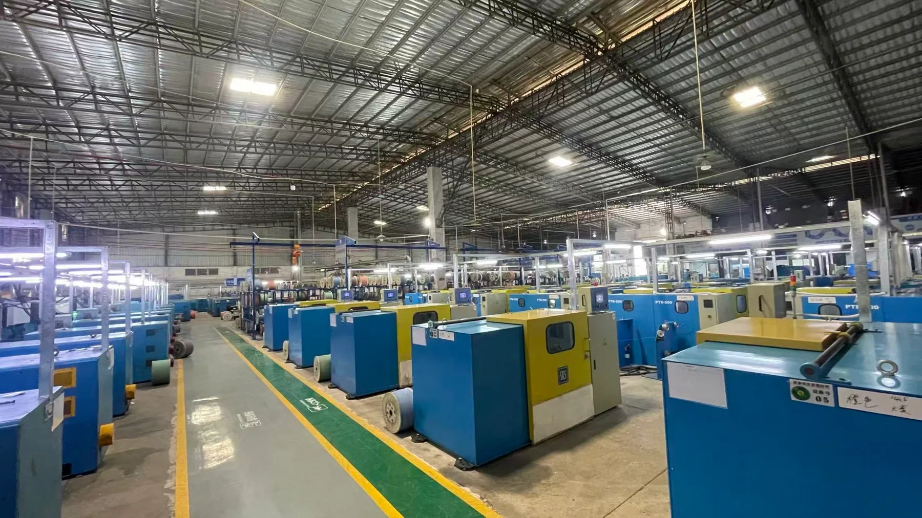 Cable-processing equipment and reels in a NexBridge partner factory production area